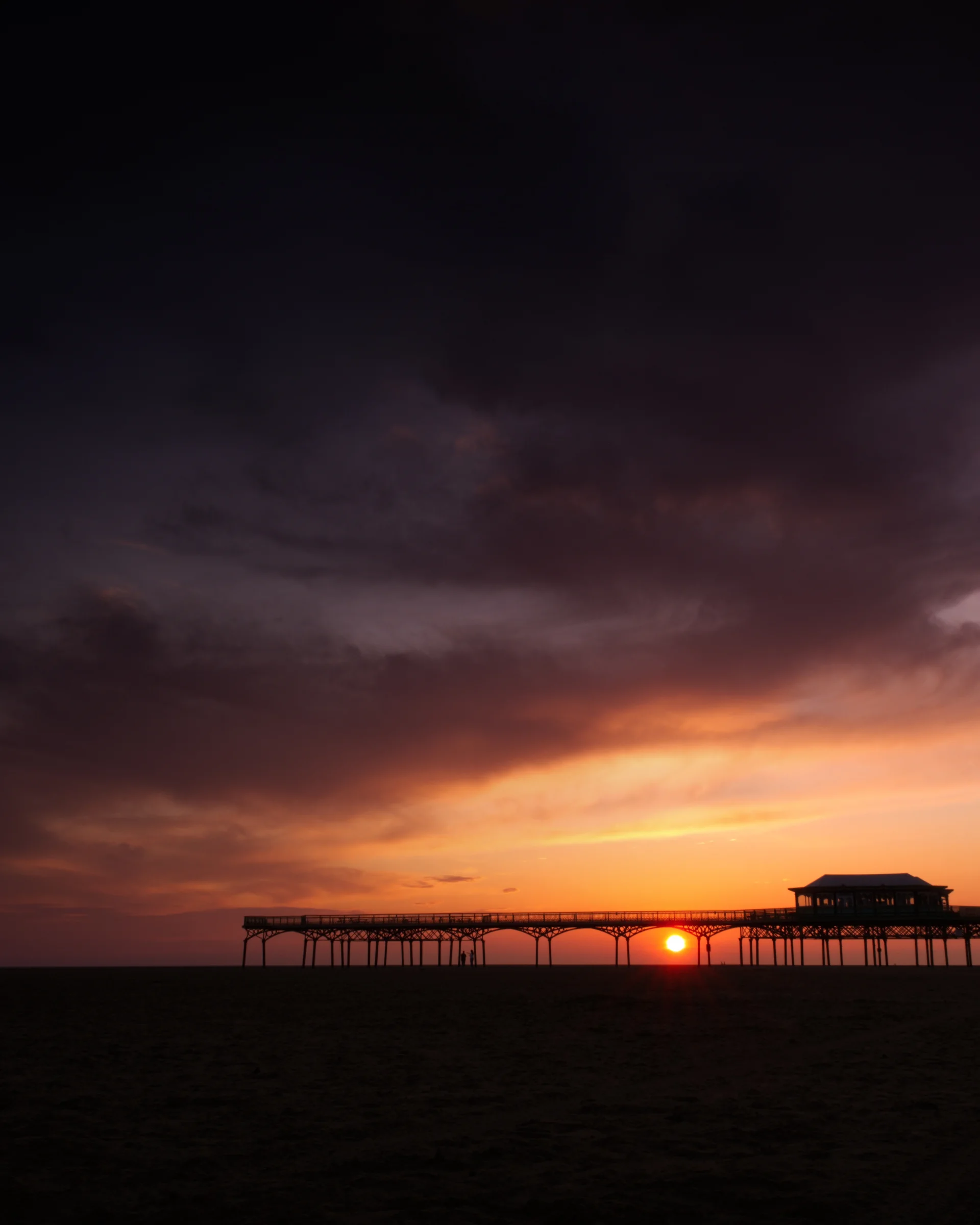 There's a strong chance this image contains the following subjects: sky,  water,  sea,  sunset,  beach,  sun,  storm,  ocean,  lytham,  lythamstannes,  pier,  evening,  dusk. The photographer has provided the following description: Lytham St Annes Pier during sunset in 2025 Photographer_name: Chris Michael. Title: The Pier. The photographer has provided the following description: Lytham St Annes Pier during sunset in 2025 Make: fujifilm. Model: X-T5. Technical: XF16-80mm. Published: 2025-09-06 19:18:42