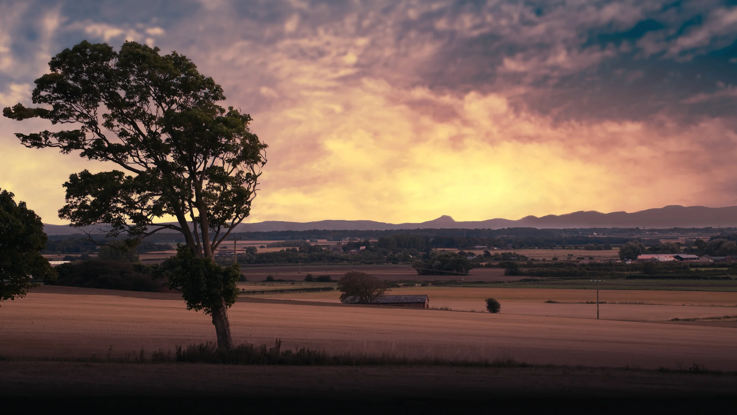 There's a strong chance this image contains the following subjects: tree,  sky,  water,  landscape,  sunset,  dawn,  ormskirk,  evening,  snowdonia,  eryri,  snowdon. The photographer has provided the following description: It's hard to believe that you can see the stunning mountains around Snowdonia (Eryri) from here in Ormskirk in West Lancashire. In fact, you can see the beast himself Yr Wydffa (Snowdon!) just off centre.  Photographer_name: Chris Michael. Title: Snowdon from Ormskirk. The photographer has provided the following description: It's hard to believe that you can see the stunning mountains around Snowdonia (Eryri) from here in Ormskirk in West Lancashire. In fact, you can see the beast himself Yr Wydffa (Snowdon!) just off centre.  Make: canon. Model: EOS R. Technical: Canon RF70-200mm. Published: 2025-09-05 19:21:04
