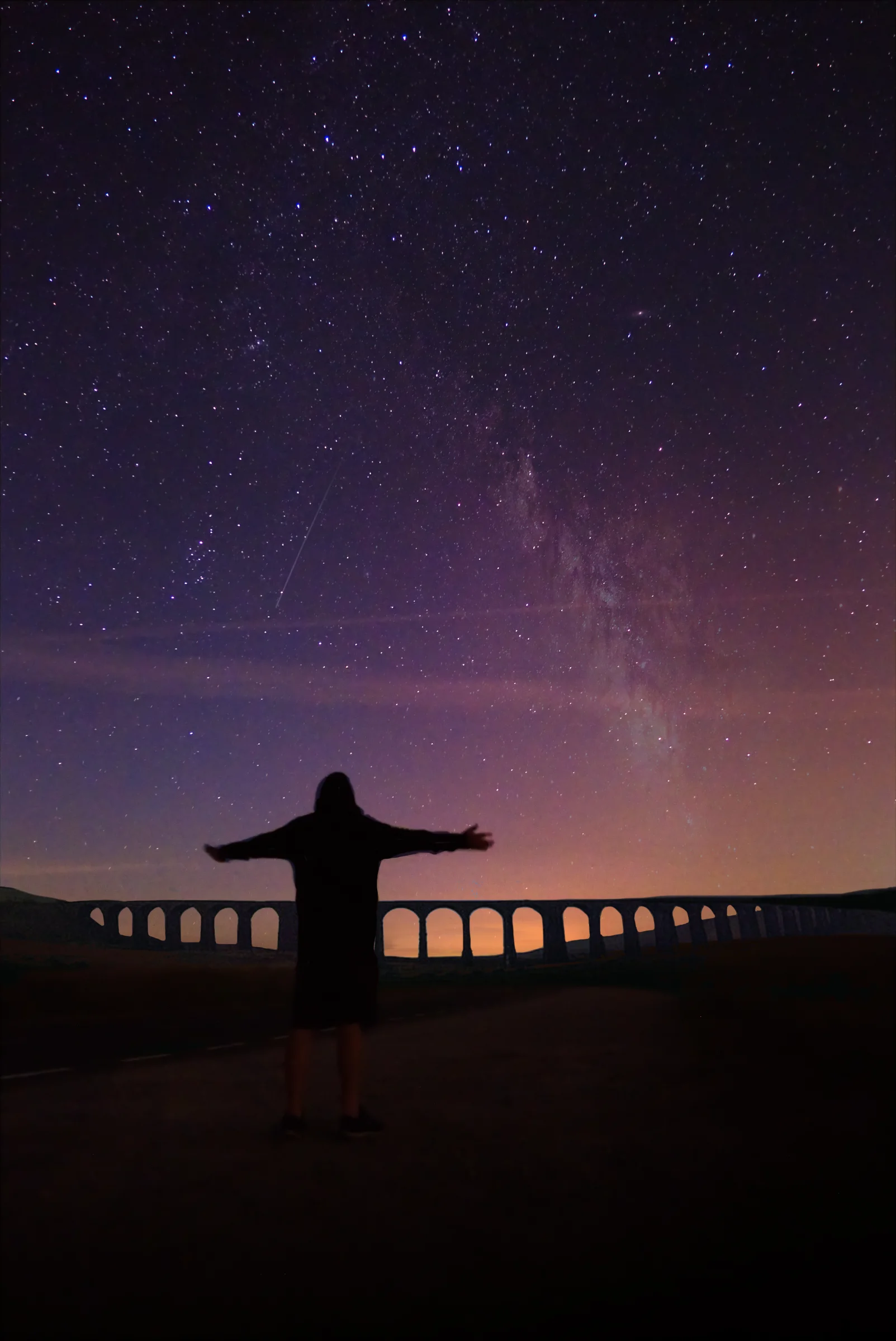 There's a strong chance this image contains the following subjects: sky,  light,  landscape,  auroraborealis,  northernlights,  stars,  milkyway,  silhouette,  moon,  astronomy. The photographer has provided the following description: Here I am in Yorkshire at the gorgeous Ribblehead Viaduct not only with a million stars, but with the Aurora Borealis and Milky Way overhead Photographer_name: Chris Michael. Title: Northern Lights in Yorkshire. The photographer has provided the following description: Here I am in Yorkshire at the gorgeous Ribblehead Viaduct not only with a million stars, but with the Aurora Borealis and Milky Way overhead Make: fujifilm. Model: x-t5. Technical: 16mm. 30second shot.. Published: 2025-09-07 23:26:45
