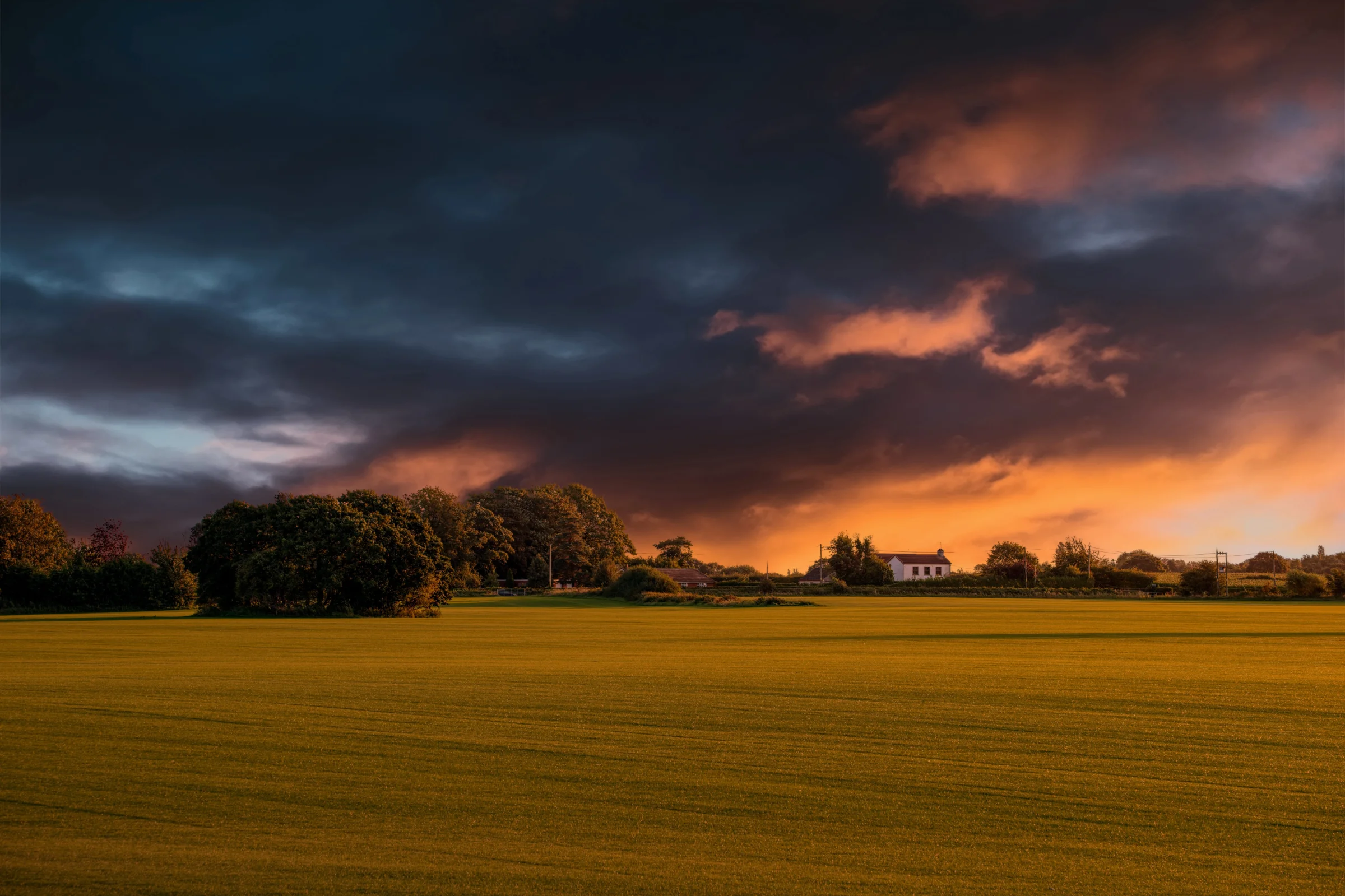 There's a strong chance this image contains the following subjects: sky,  landscape,  sunset,  fall,  dawn,  cropland,  field,  farm,  sun,  grass,  rural,  countryside,  merseyside. The photographer has provided the following description: Taken in the evening in Lydiate, Sefton, Merseyside. This landscape caught my eye as I was driving past. Photographer_name: Chris Michael. Title: Sunset in Lydiate. The photographer has provided the following description: Taken in the evening in Lydiate, Sefton, Merseyside. This landscape caught my eye as I was driving past. Make: fujifilm. Model: X-T5. Technical: 16-80MM. Published: 2025-09-07 22:24:14