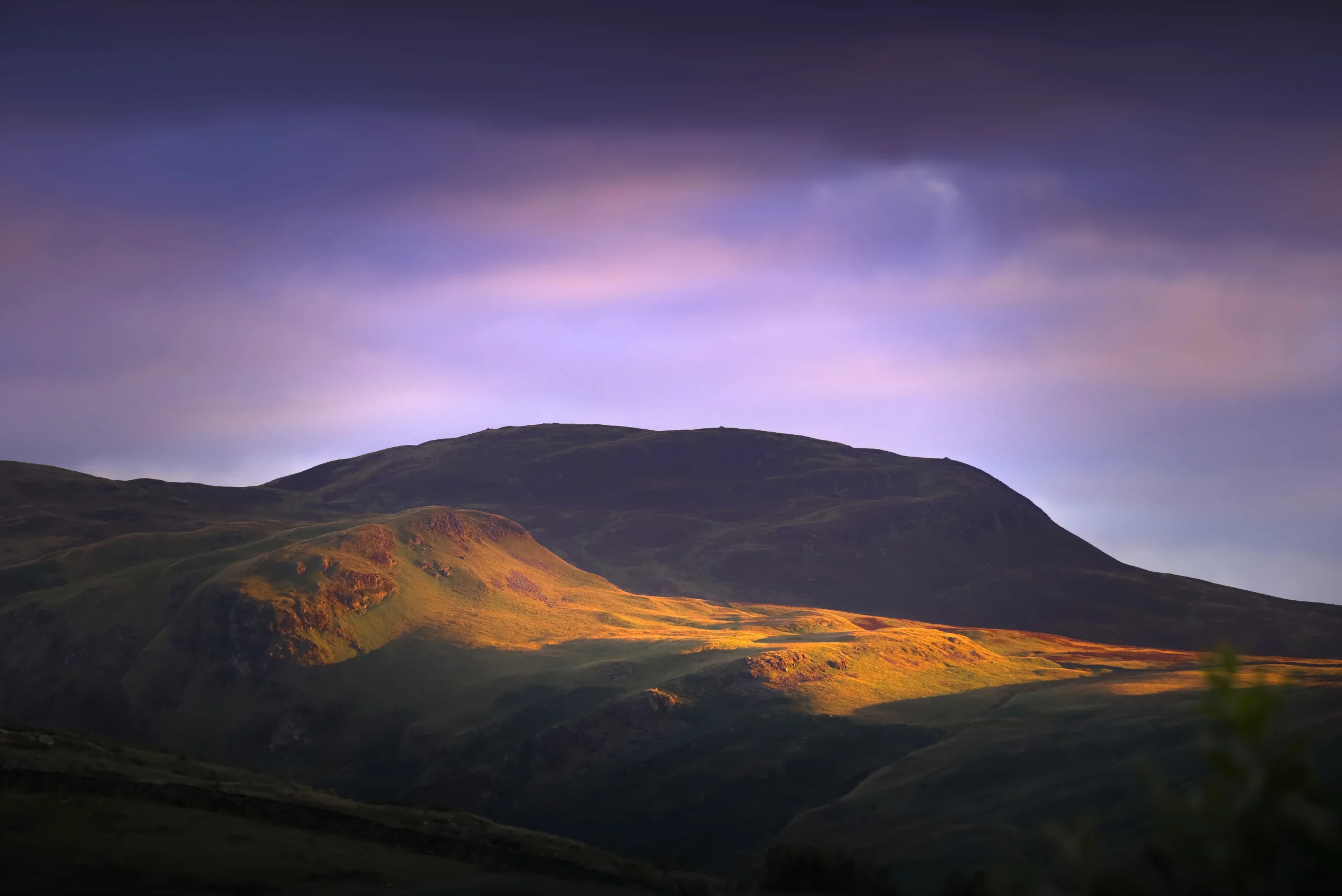 There's a strong chance this image contains the following subjects: sky,  landscape,  sunset,  nature,  dawn,  hill,  cumbria,  lakedistrict. The photographer has provided the following description: Just before sunset, and the sun streaked across the hillside in Keswick, Cumbria. Mesmerising. Photographer_name: Chris Michael. Title: Sunset in Keswick. The photographer has provided the following description: Just before sunset, and the sun streaked across the hillside in Keswick, Cumbria. Mesmerising. Make: fujifilm. Model: X-T5. Technical: 16-80mm. Published: 2025-09-07 22:55:15