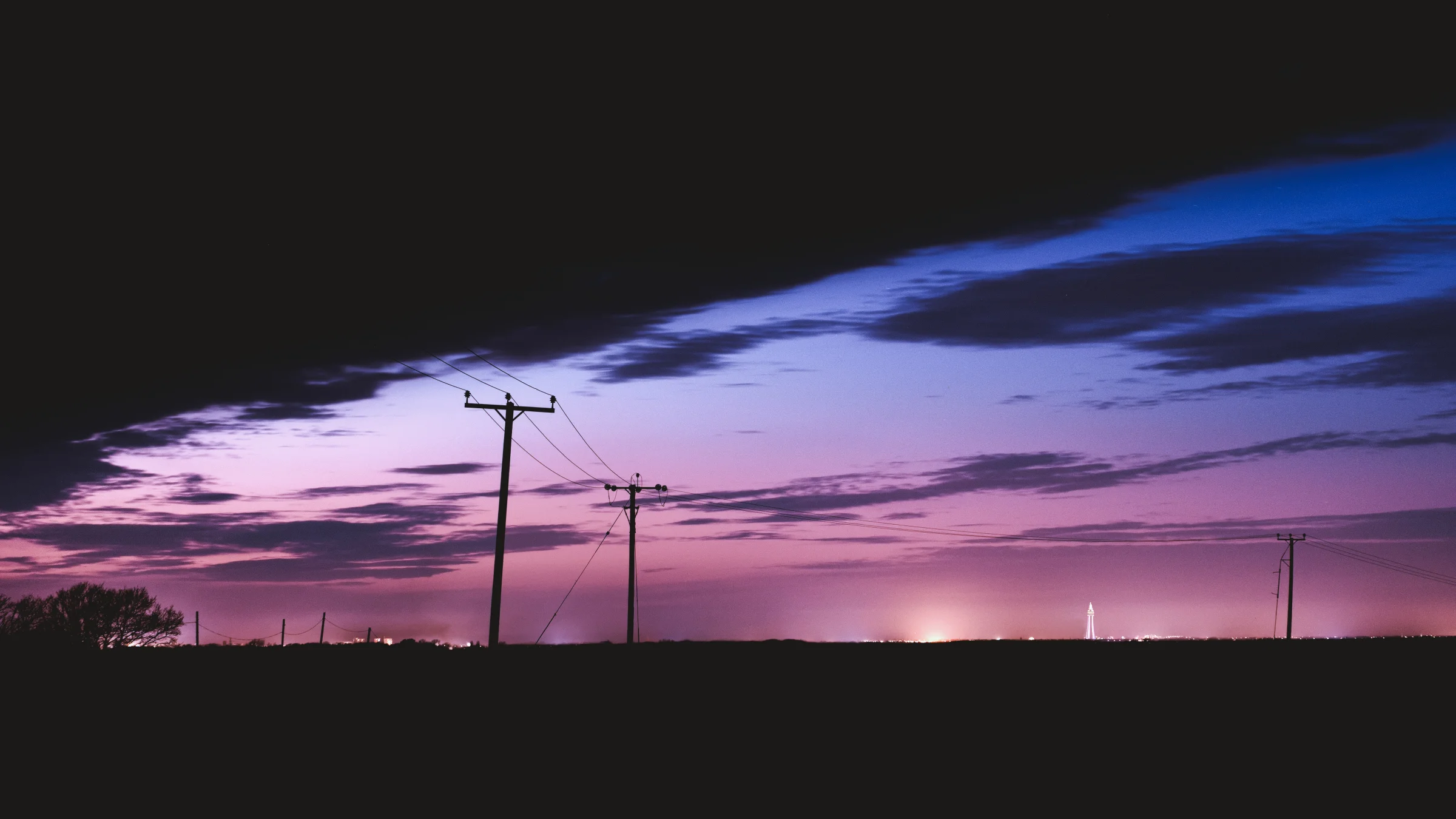 There's a strong chance this image contains the following subjects: sky,  light,  landscape,  sunset,  nature,  dawn,  lancashire,  ormskirk,  auroraborealis,  northernlights,  silhouette. The photographer has provided the following description: Whilst this may look like a sunset shot, it isn't. This is the Aurora Borealis (Northern Lights) taken way after sunset, looking north of course. It was taken from a farmer's field in Ormskirk, Lancashire...but can you spot Blackpool Tower in the photo? It's crazy to think you can see Blackpool from Ormskirk. Photographer_name: Chris Michael. Title: Ormskirk Aurora. The photographer has provided the following description: Whilst this may look like a sunset shot, it isn't. This is the Aurora Borealis (Northern Lights) taken way after sunset, looking north of course. It was taken from a farmer's field in Ormskirk, Lancashire...but can you spot Blackpool Tower in the photo? It's crazy to think you can see Blackpool from Ormskirk. Make: canon. Model: EOS R. Technical: Canon RF16mm. Published: 2025-09-06 18:30:02