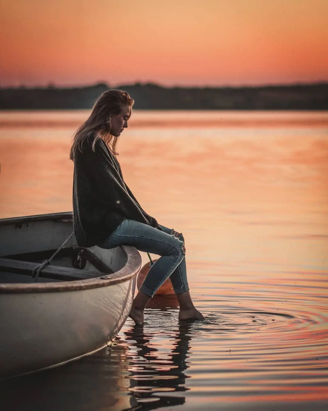 There's a strong chance this image contains the following subjects: water,  travel,  sea,  sunset,  woman,  dawn,  beach. The photographer has provided the following description: Nikon D500, Nikkor 85mm f.1/8 Source: https://www.instagram.com/dennis_visuals/ Photographer_name: DES. Title: Evenings at the lake. The photographer has provided the following description: Nikon D500, Nikkor 85mm f.1/8 Published: 2025-06-25 09:17:20